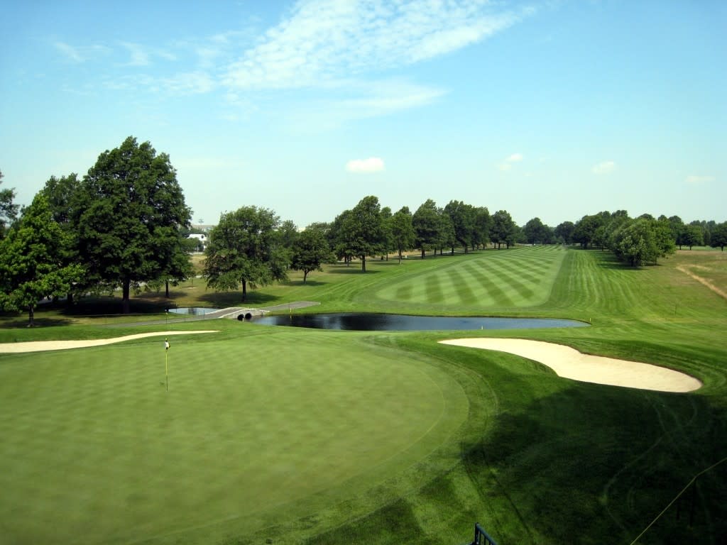 The golf course — green, pond, and fairway
